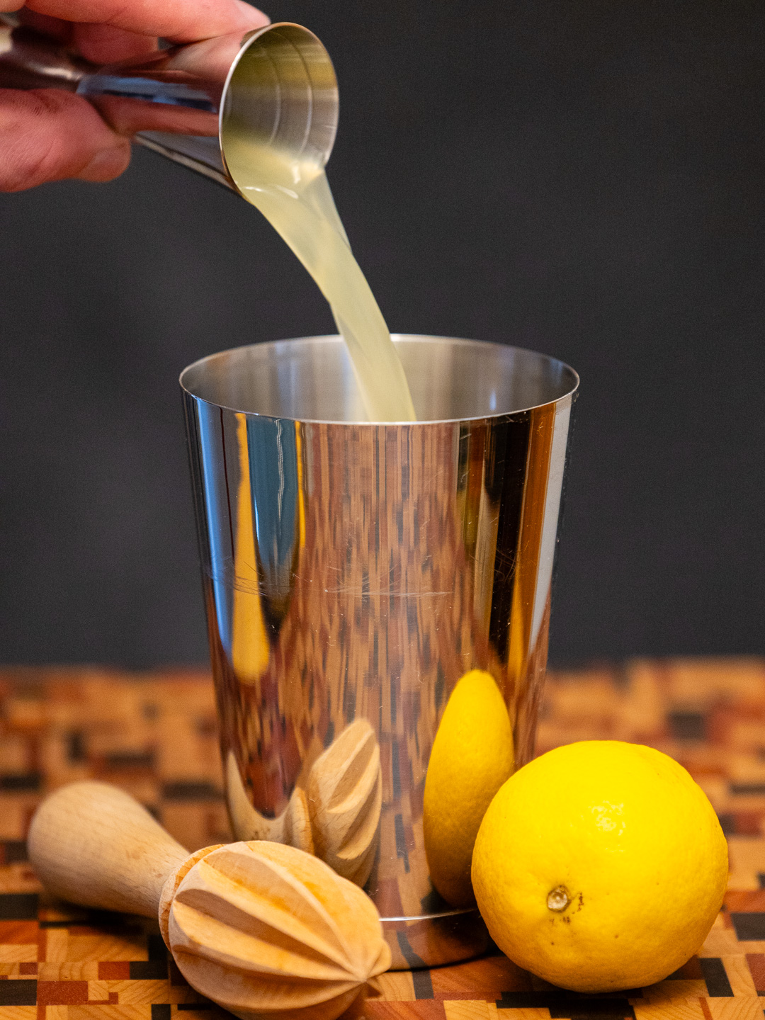 Pouring lemon juice into a cocktail shaker
