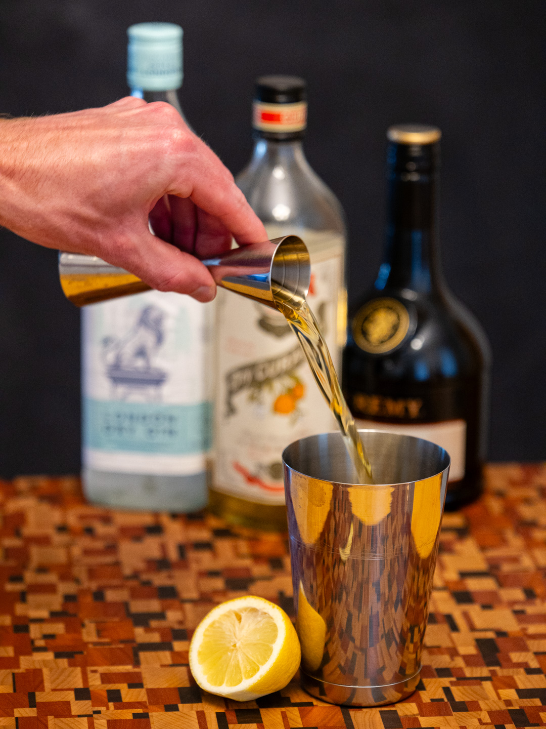 Pouring brandy into a mixing glass