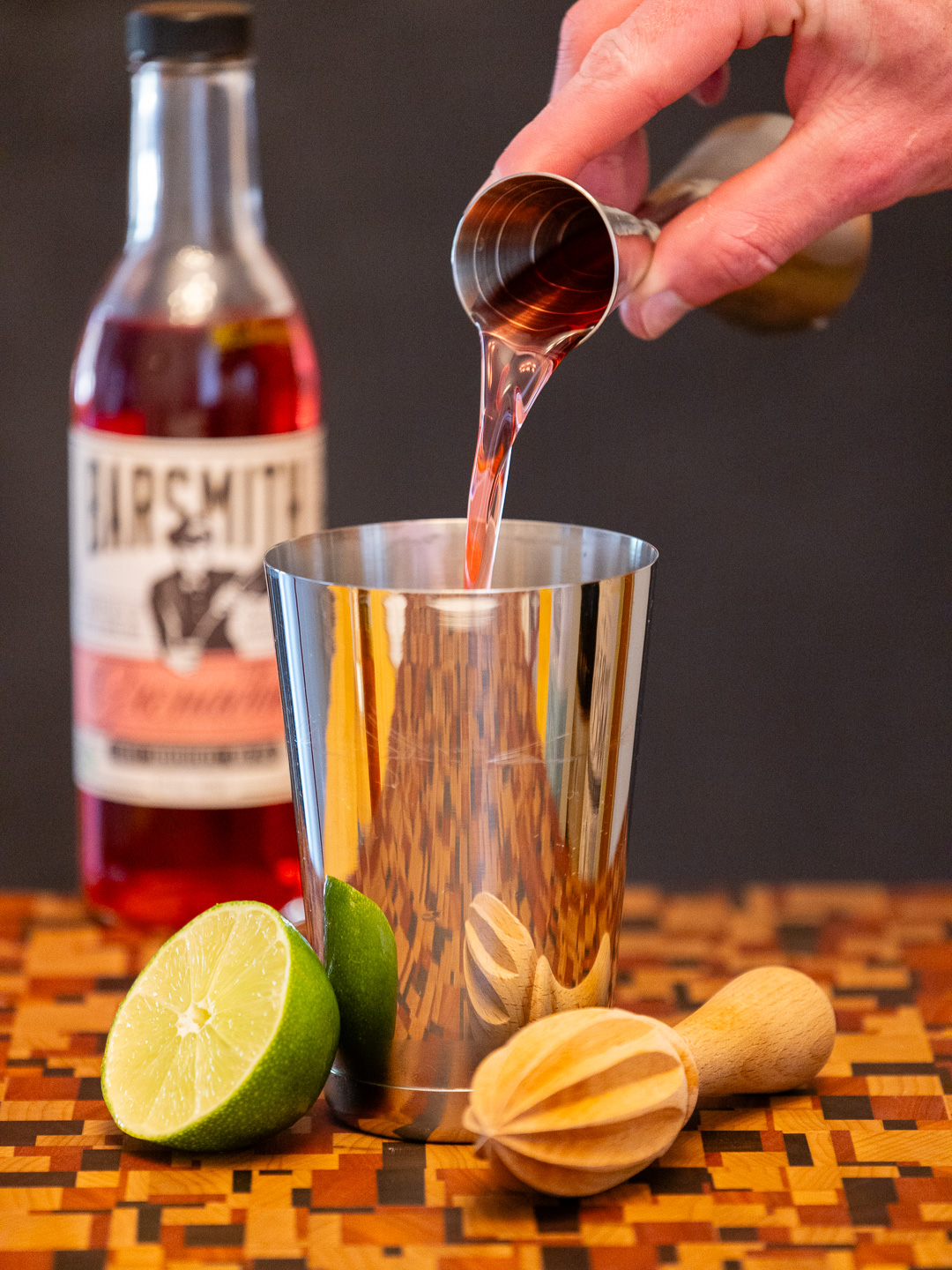 Pouring grenadine into a cocktail shaker