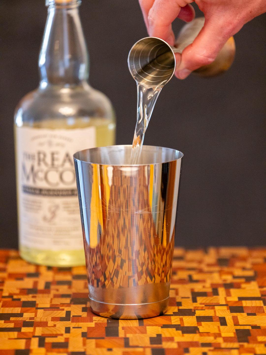 Pouring white rum into a cocktail shaker