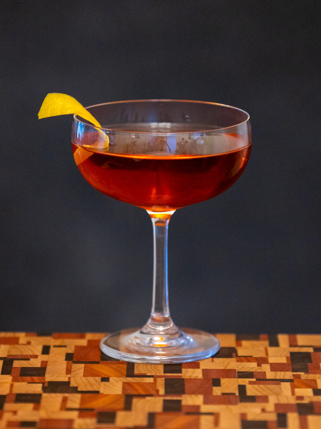 The Beauty Beneath cocktail in a coupe glass
